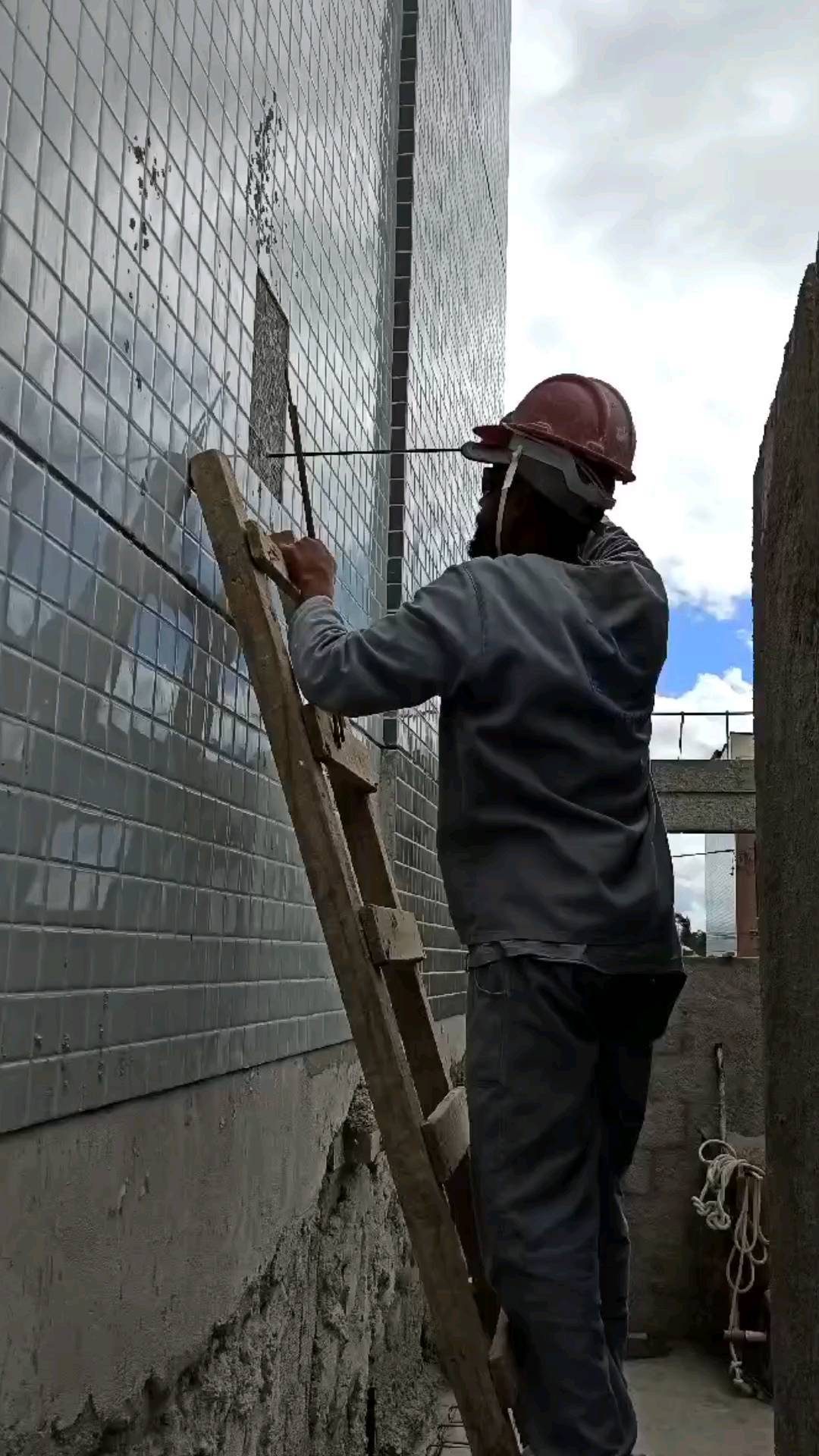 Profissional da Uhomed fazendo manutenção no revestimento de uma fachada em Recife